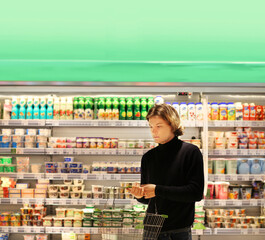 Young man shopping in supermarket, reading product information