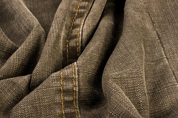 clothing items stonewashed cotton fabric texture with seams, clasps, buttons and rivets, macro
