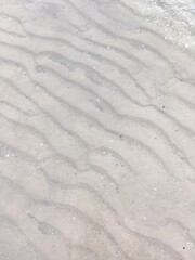 Beautiful background image. Gentle waves in soft white sand. A vacationer's dream.