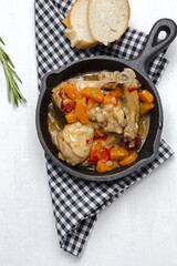 Homemade beer chicken stew with vegetables and aromatic herbs
