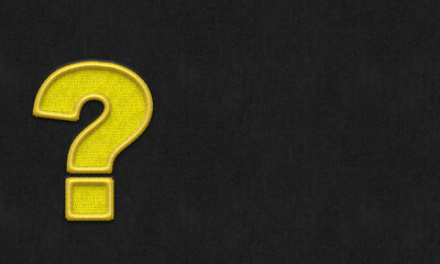 Question mark embroidery on dark background.