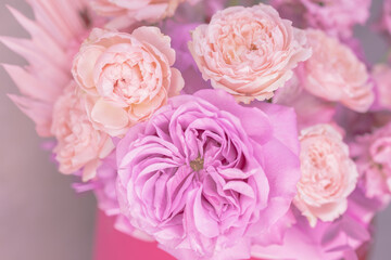 Fototapeta na wymiar Light pink, purple, peach colour, white cute delicate small roses of different sizes, flowers in a lush bouquet. Macro