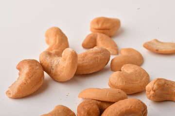 Heap of cashew nuts isolated on white background.