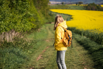 Woman hiking in rural landscape at springtime. Walk outdoors