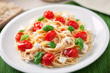 Spaghetti with cherry tomatoes and fresh ricotta on a plate.