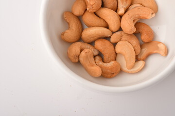 Heap of cashew nuts isolated on white background.