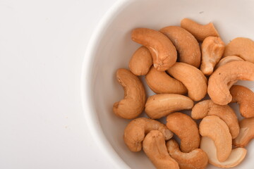 Heap of cashew nuts isolated on white background.