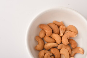 Heap of cashew nuts isolated on white background.