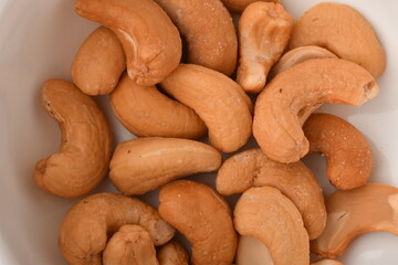 Heap of cashew nuts isolated on white background.