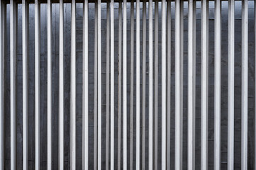 Obraz premium Vertical aluminium fence on concrete wall background