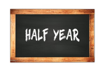 Fototapeta premium HALF YEAR text written on wooden frame school blackboard.