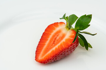 Red ripe strawberry slice isolated on white background