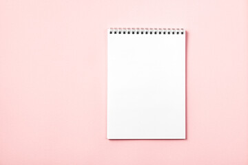 Notebook on a pink background.