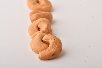 Heap of cashew nuts isolated on white background.
