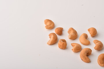 Heap of cashew nuts isolated on white background.