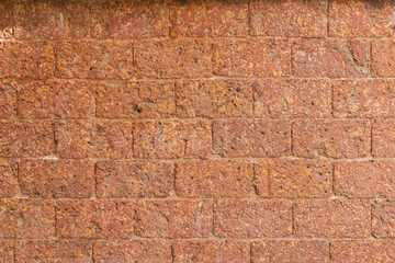 blur of red laterite brick wall Porous and fine-grained Background pattern