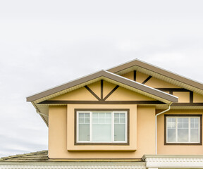 The top of the house or apartment building with nice window.