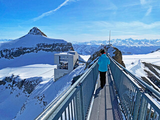 Peak walk on the Suspension bridge between two mountain peaks (Travel destination Glacier 3000) or...