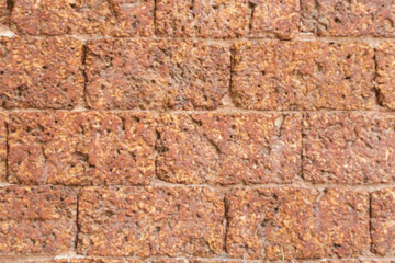 blur of red laterite brick wall Porous and fine-grained Background pattern