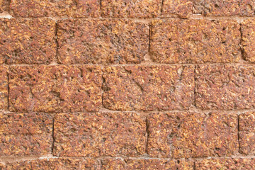 blur of red laterite brick wall Porous and fine-grained Background pattern