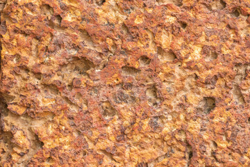 blur of red laterite brick wall Porous and fine-grained Background pattern