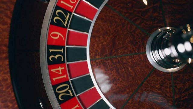 Close up of roulette wheel at the casino in motion. The wheel ball is spinning. Concept of casino and gambling.