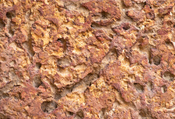 blur of red laterite brick wall Porous and fine-grained Background pattern