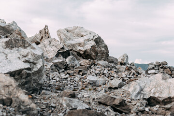 Mining process. Rocks for mining. Big gray limestone.