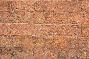blur of red laterite brick wall Porous and fine-grained Background pattern