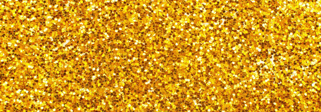 glittering background of golden sequins closeup. Sparkle festive texture. banner