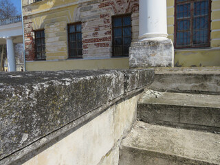 An old abandoned building with columns on a sunny day.