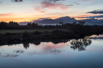 Sunset at the wetlands of Albufereta in the north of Mallorca with the mountain range Serra de Tramuntana in the background.