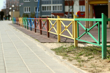 Colorful fence and playground with blurred background