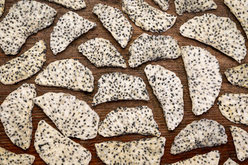 slices of dried white dragon fruit against rustic weathered wood