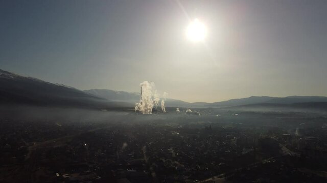 Foggy morning and smoking factory chimneys during sunrise drom drone footage 4k