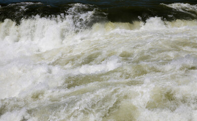 Natural background. Power in water. Closeup view of the waterfall white water beautiful texture, motion and pattern.