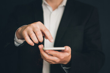 Businessman in a suit with a phone in his hands. Man with a phone in his hands