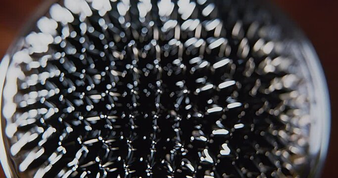 Lights over a black ferro fluid magnetic surface