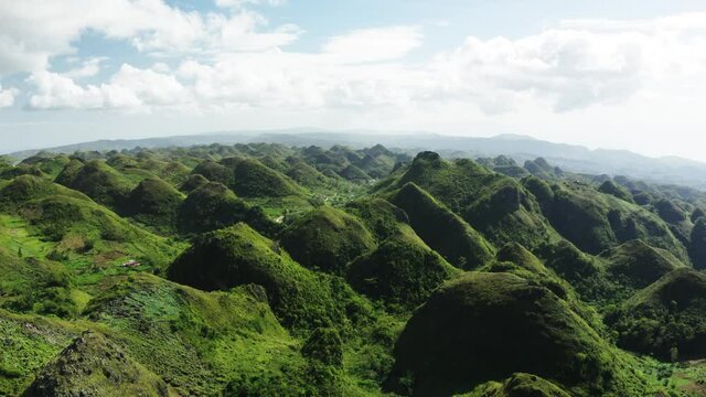 Chocolate Hills in Cebu, Philippines. Green hills with regular shapes, popular spot for hike. Aerial panorama, 4k