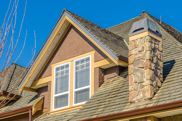 The roof of the house with nice window.