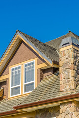 The roof of the house with nice window.