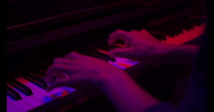 Close up of finger musician at the piano , The pianist playing  piano in the room ,classic piano,neon light,funny,hobby.