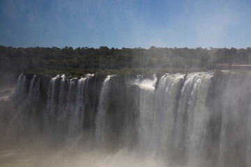 Natural world wonder. The Iguazu falls in the forest. View of the mist and white water falling seen from Garganta del Diablo in Iguazu national Park, Misiones, Argentina.