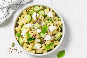 Summer party menu cucumber feta pasta salad. Space for text, top view.