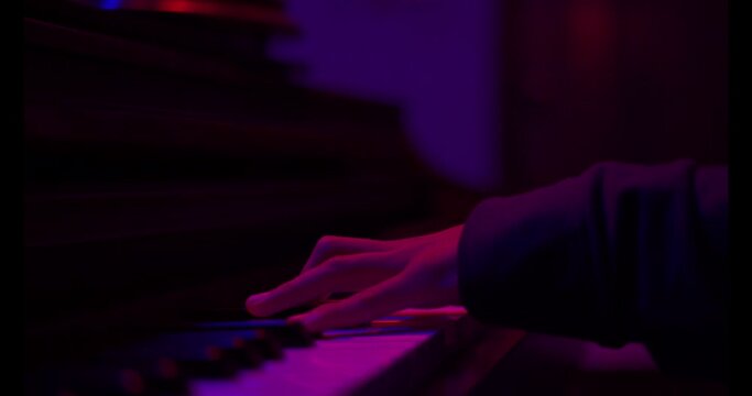 Close up of finger musician at the piano , The pianist playing  piano in the room ,classic piano,neon light,funny,hobby.