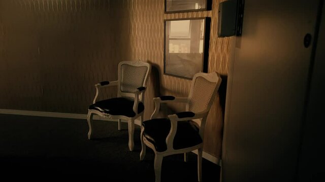Creepy corridor on a abandoned house. Furniture on a haunted house with a very scary and lonely corridor during a hot day. Antiquity chairs. Fancy old chairs on a corridor during the afternoon