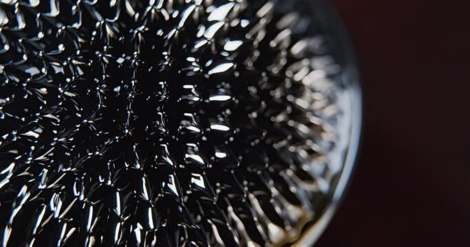 Cenital macro shoot of a ferro fluid black liquid surface