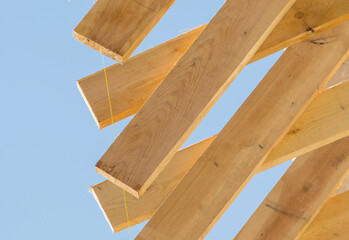 
yellow pine planks against a blue sky, exposed by level