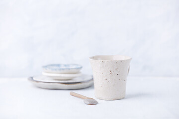 Traditional, handcrafted ceramic on bright wooden background. Soft focus. Copy space.	