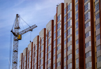 Fototapeta premium Construction site background. New multi-storey buildings. Industrial background.Building construction site work against blue sky.